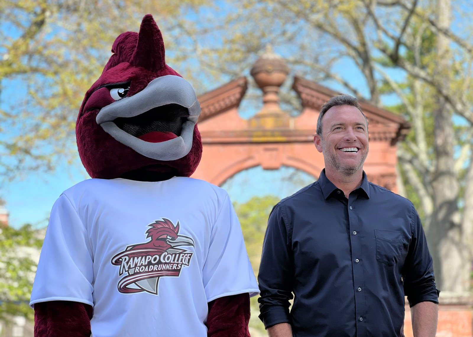 Alex-Boylan-and-RCNJ-roadrunner Alex Boylan and Ramapo College's Roadrunner mascot standing together outside of the Havemeyer Arch