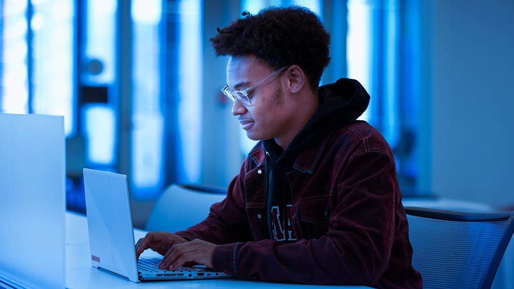 cybersecurity_spring2025-home Student on a laptop computer